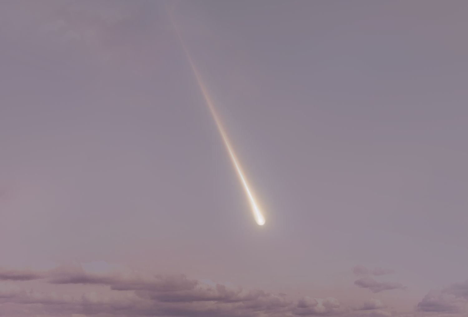 A meteor streaking through a cloudy sky