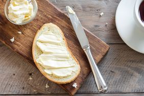 overhead view of bread and butter on a wooden surface