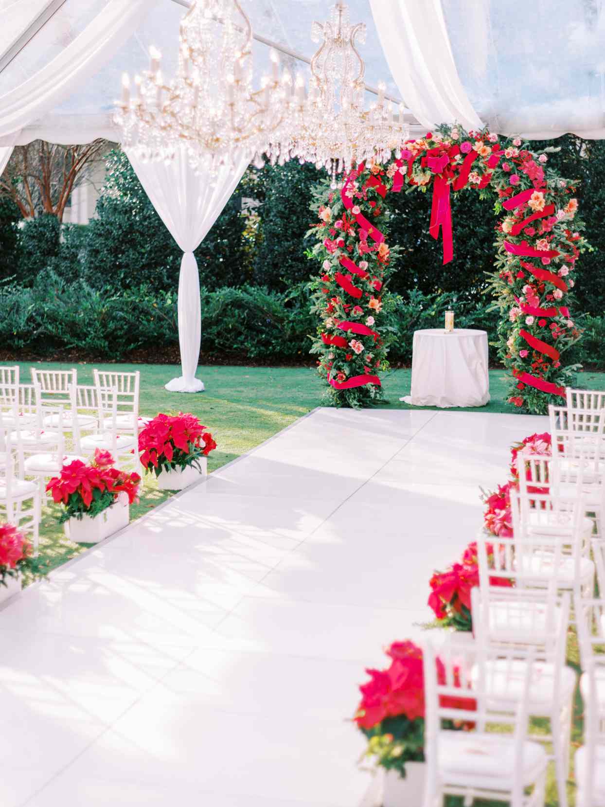 wedding ceremony set up with poinsettias lining aisle