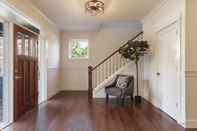 an entryway with wood floors