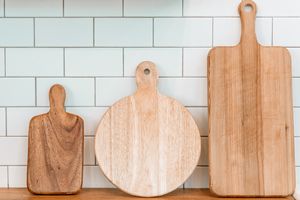Three wooden cutting boards of different shapes and sizes on a counter