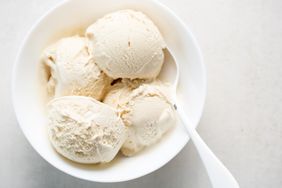 A bowl containing scoops of ice cream with a spoon
