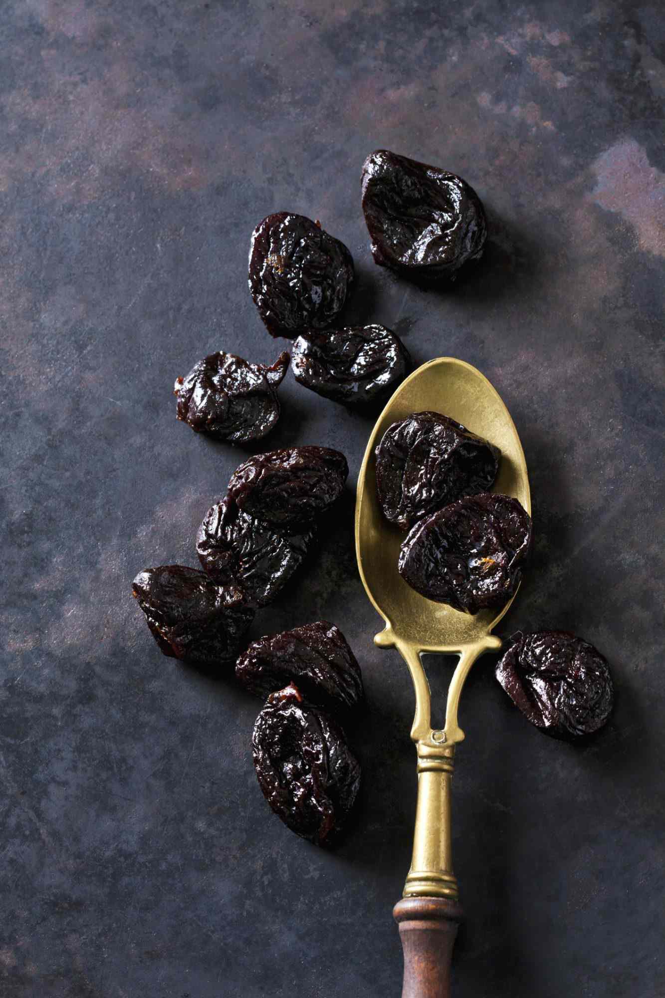 Prunes on a vintage brass spoon