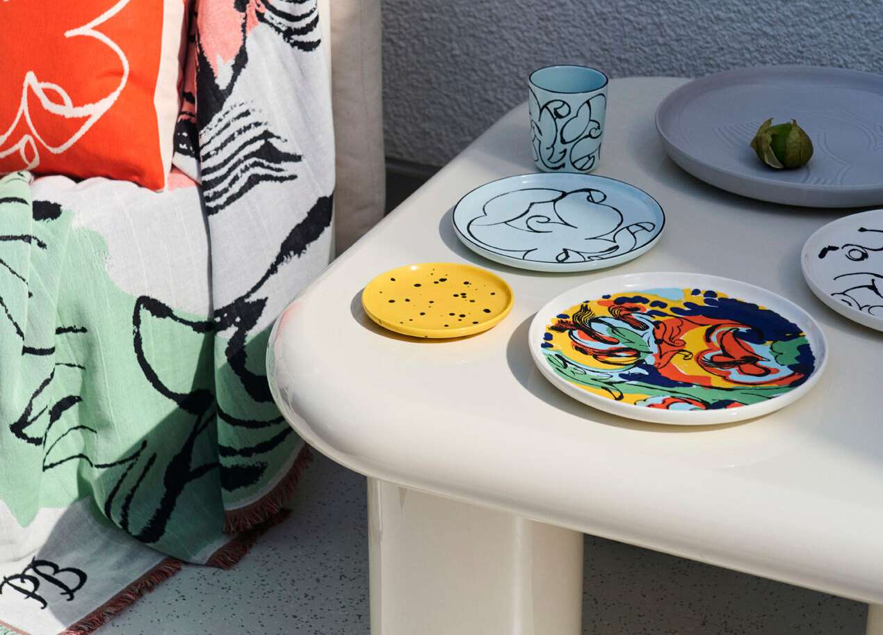 white table with colorful ceramic dishes from marimekko
