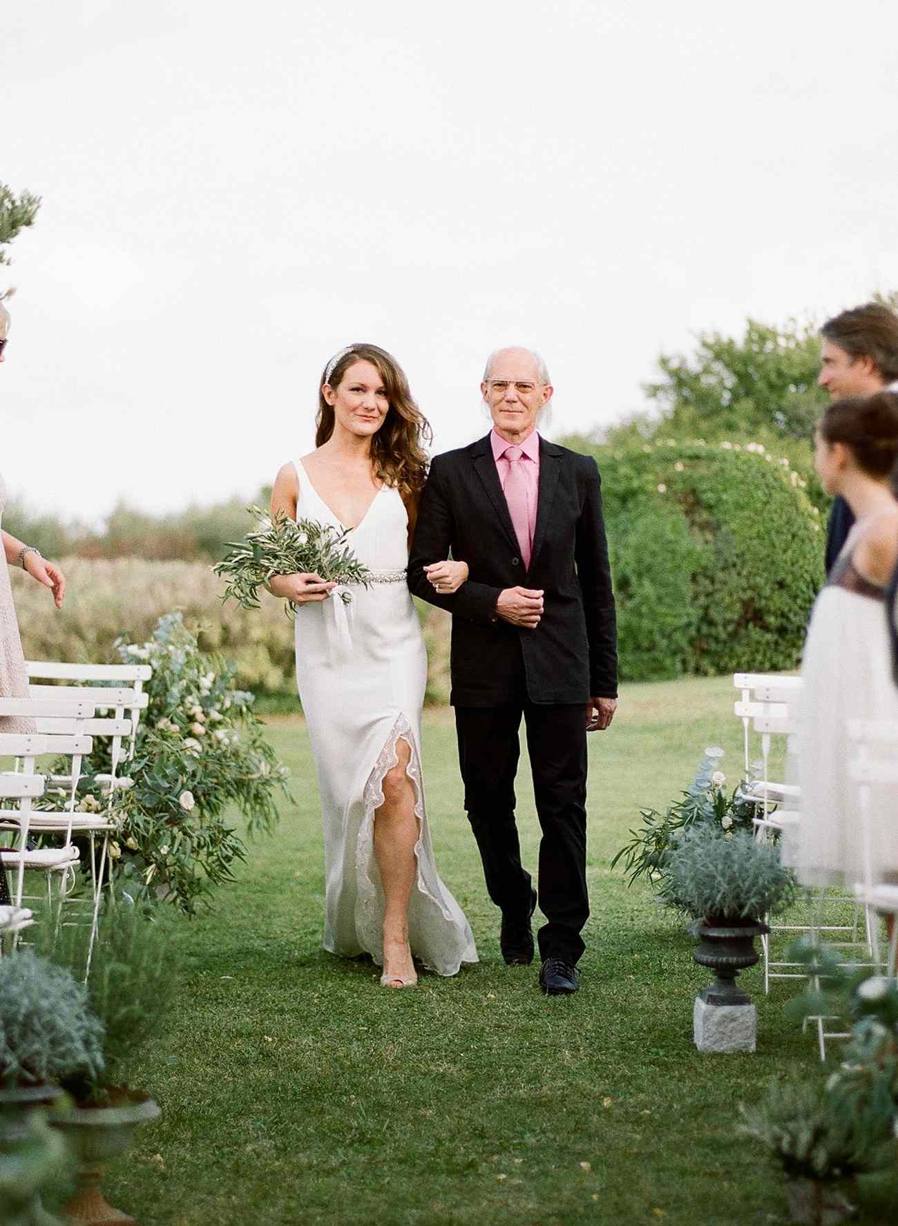 father of the bride wearing black suit with pink shirt and tie combo