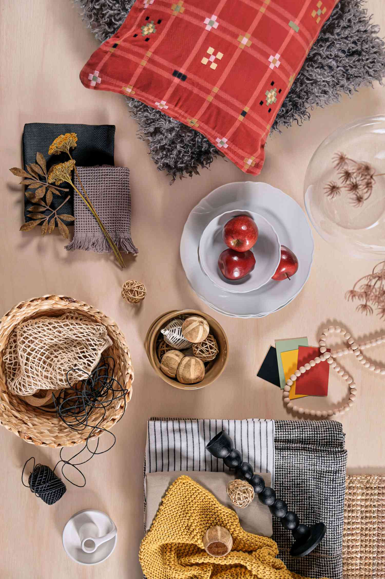 Table with plants, apples, and other items. 