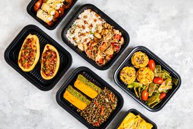 Plastic takeout boxes filled with food