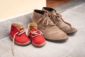 small red suede shoes and larger brown suede shoes
