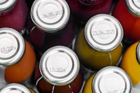 Closeup view of bottles with expiration dates printed on their caps showcasing the marked dates clearly