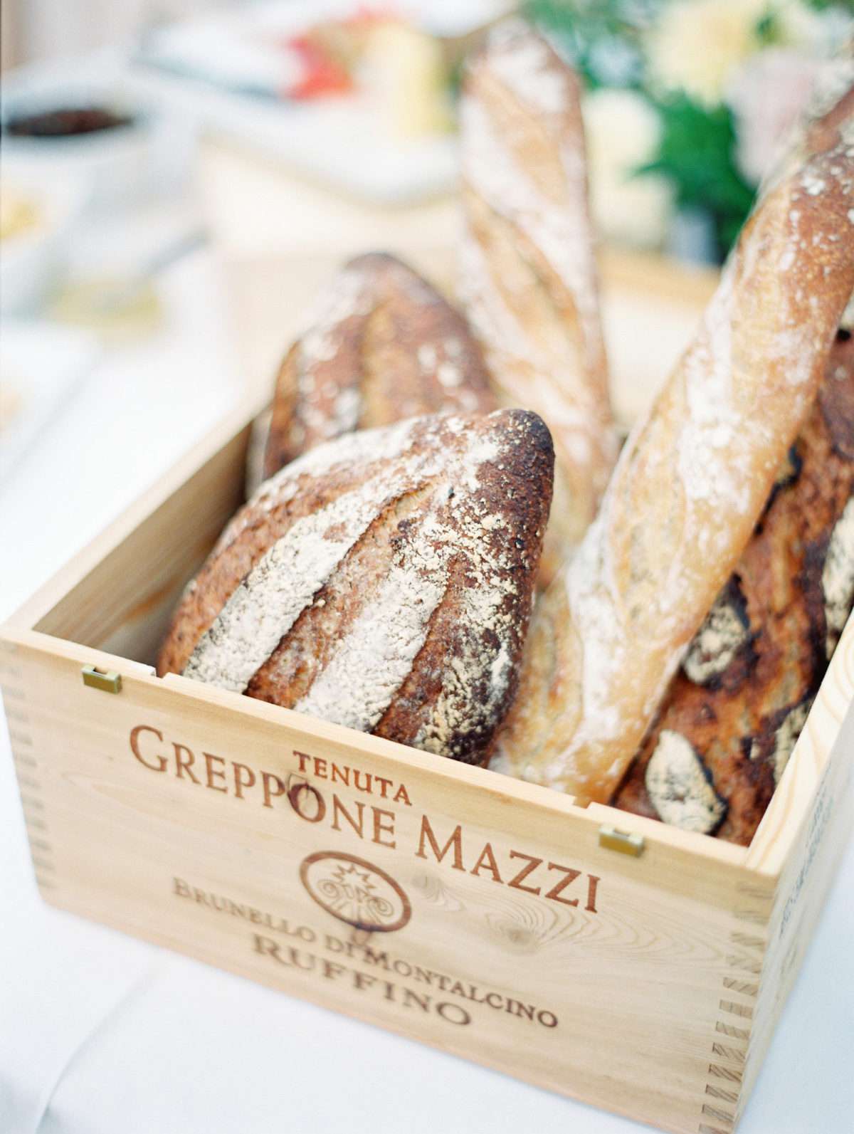 bread in wooden wine crate on table