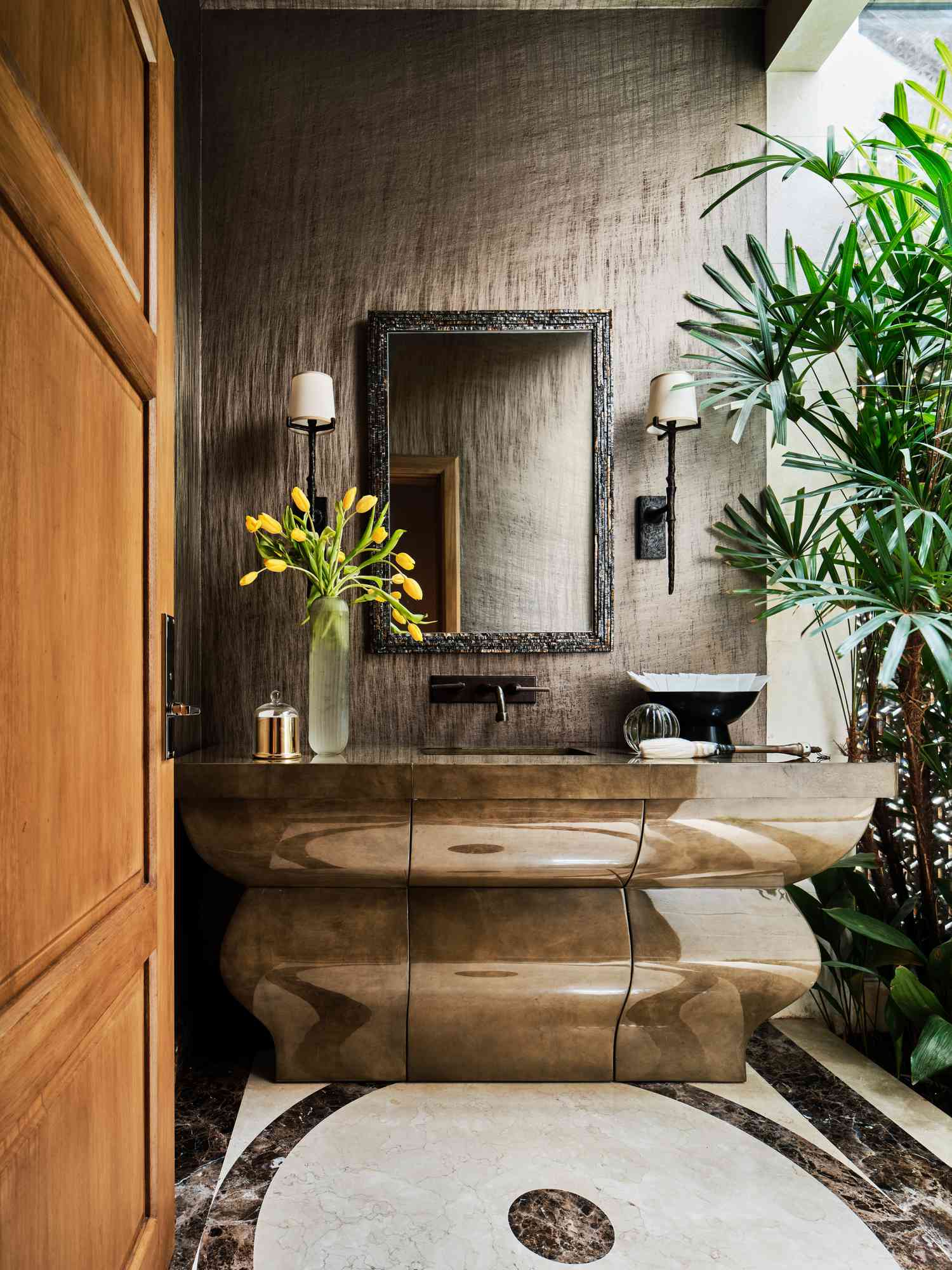 a bathroom with earth tones and bathroom mirror 