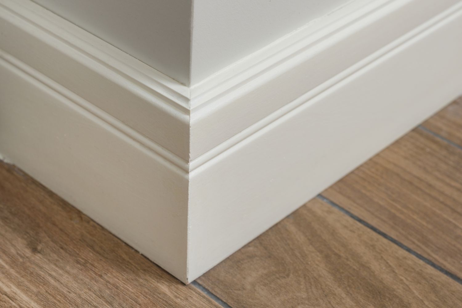 Baseboard corner detail adjacent to wood flooring