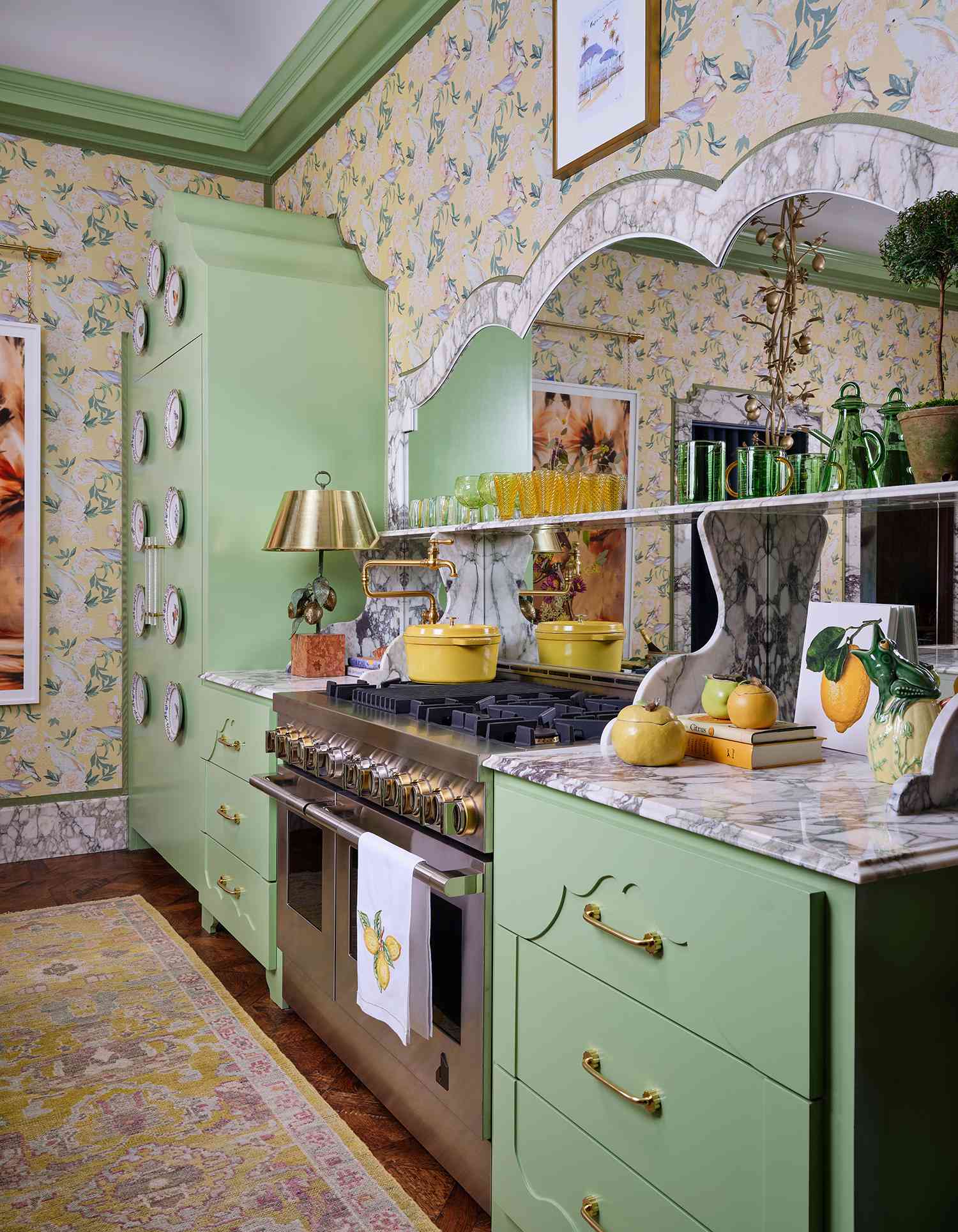 Kitchen design by Creative Tonic Design | Photography by Nick Sargent: soft green cabinetry with scalloped details, marble countertops, floral wallpaper, and brass accents create a vintage-inspired, storybook aesthetic.