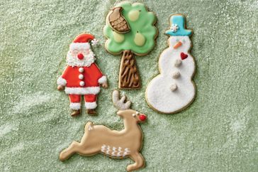Decorative Christmasthemed sugar cookies shaped as a Santa Claus a tree a snowman and a reindeer