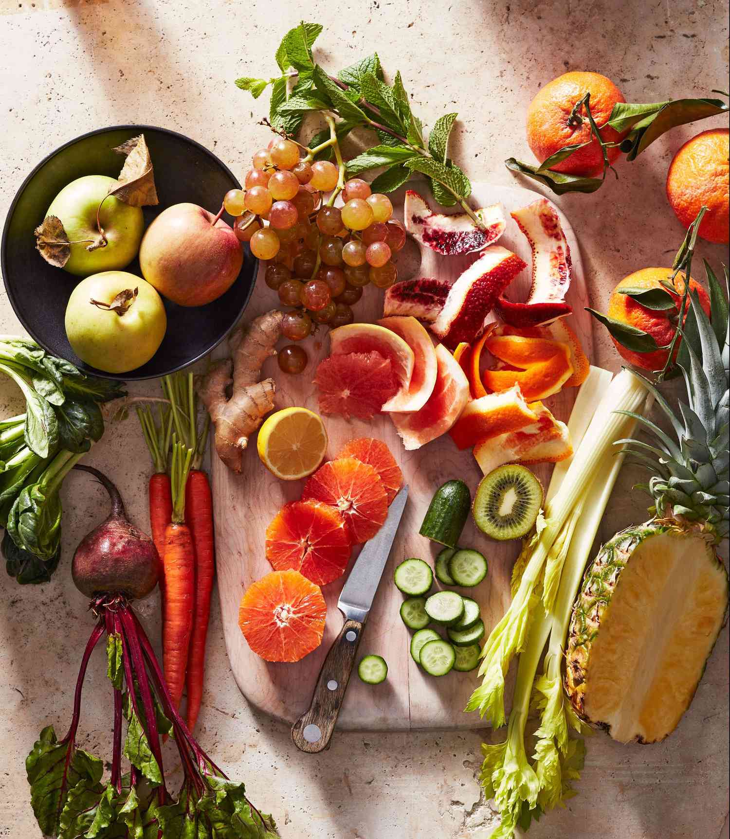 cutting board with citrus ginger cucumber beet oranges