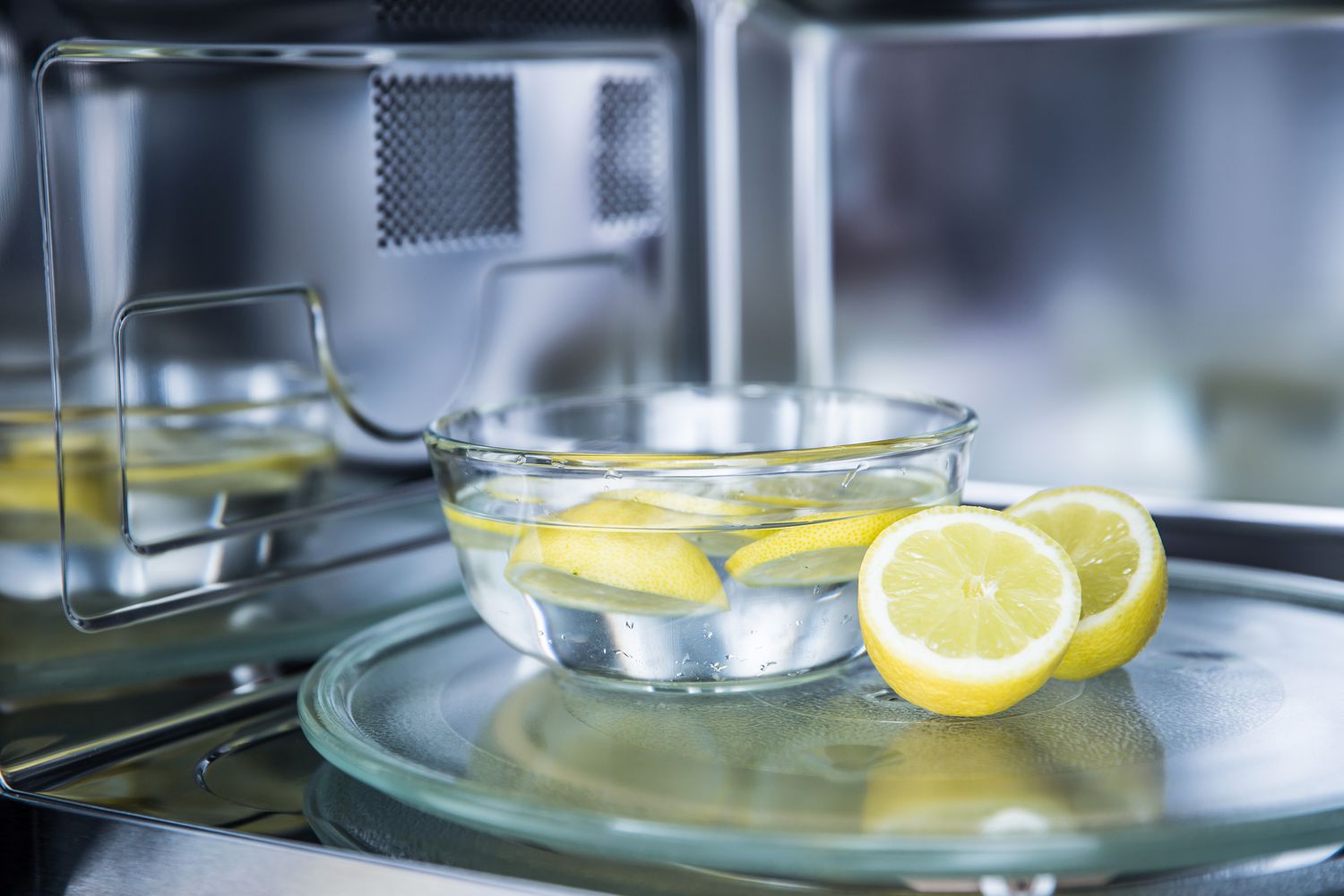 cleaning microwave with bowl of lemon water