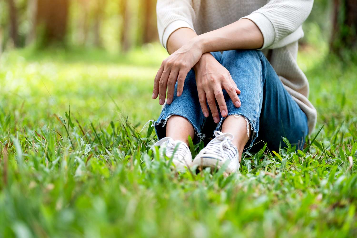 Sitting in grass with jeans 