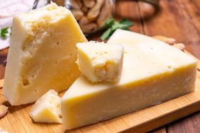 Blocks and pieces of cheese arranged on a wooden board