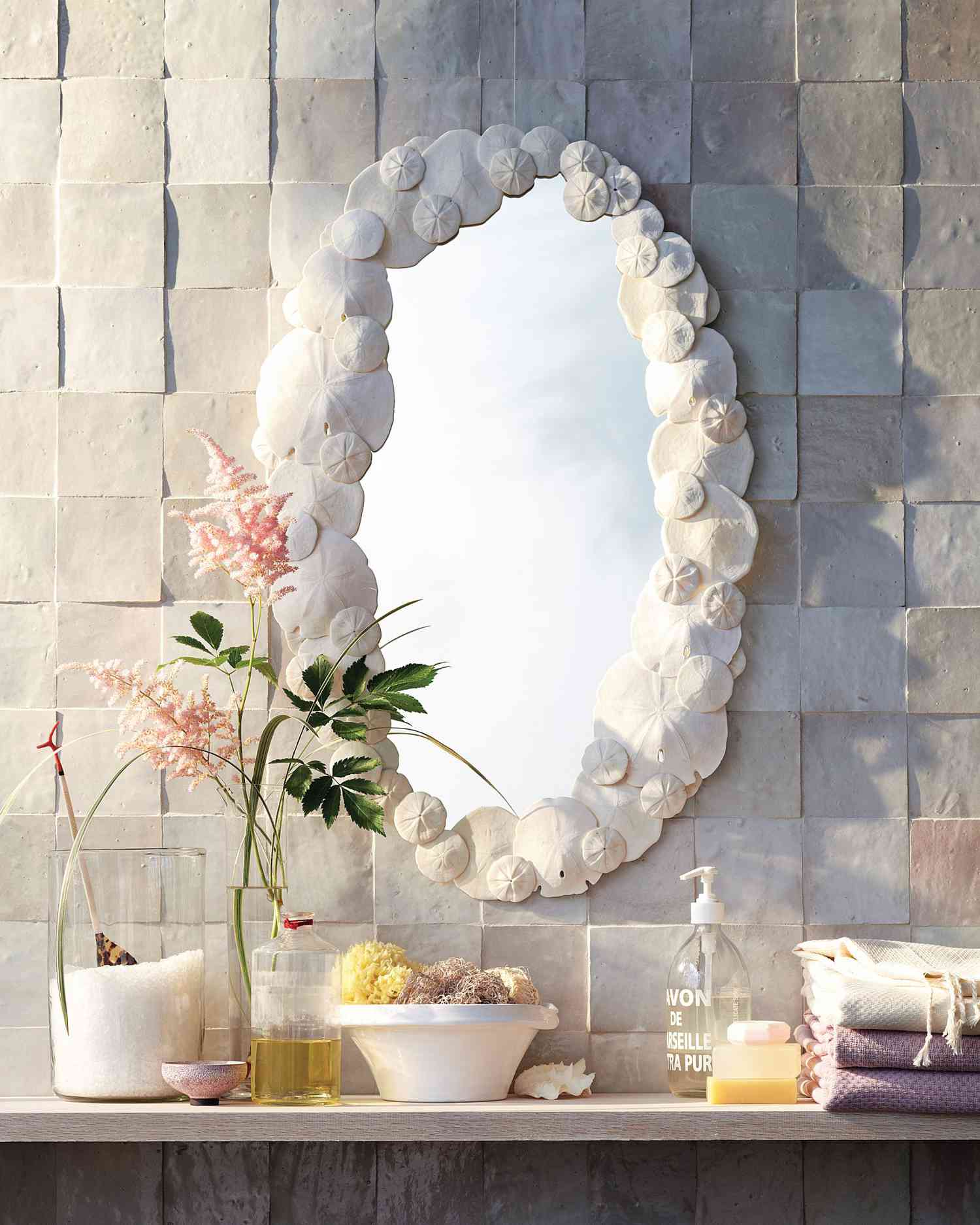 sand dollar mirror hanging on wall in bathroom