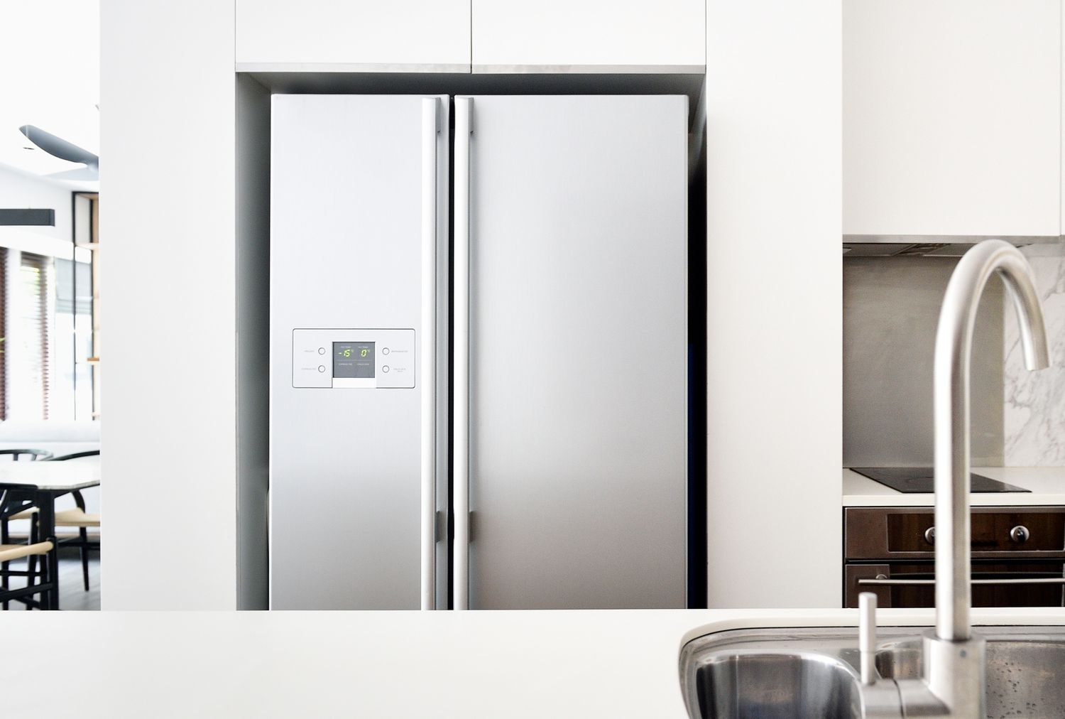 A modern kitchen with a stainless steel refrigerator and sink