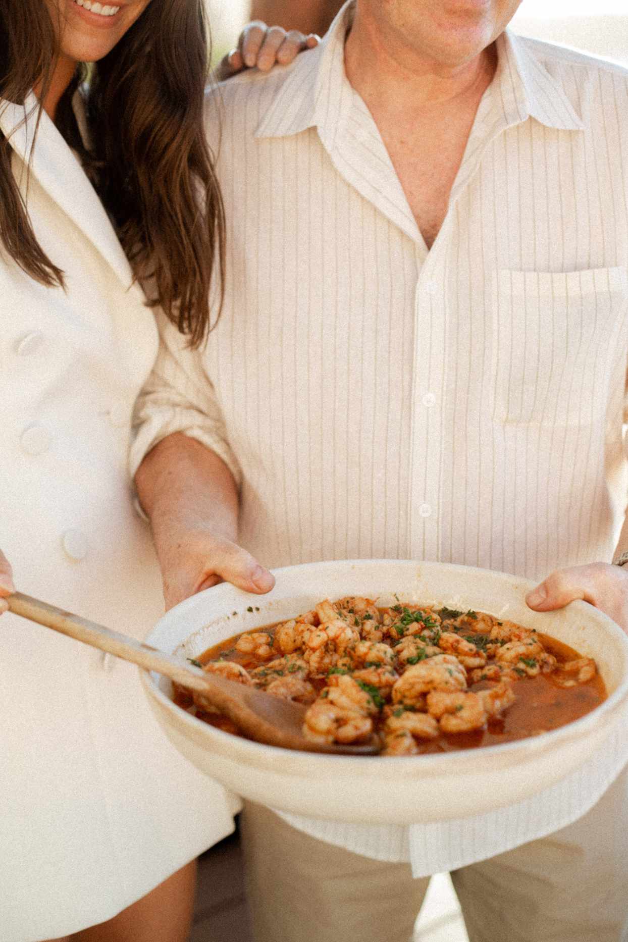 bride and groom holding wedding paella