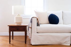 Living room with white couch and ceramic lamp