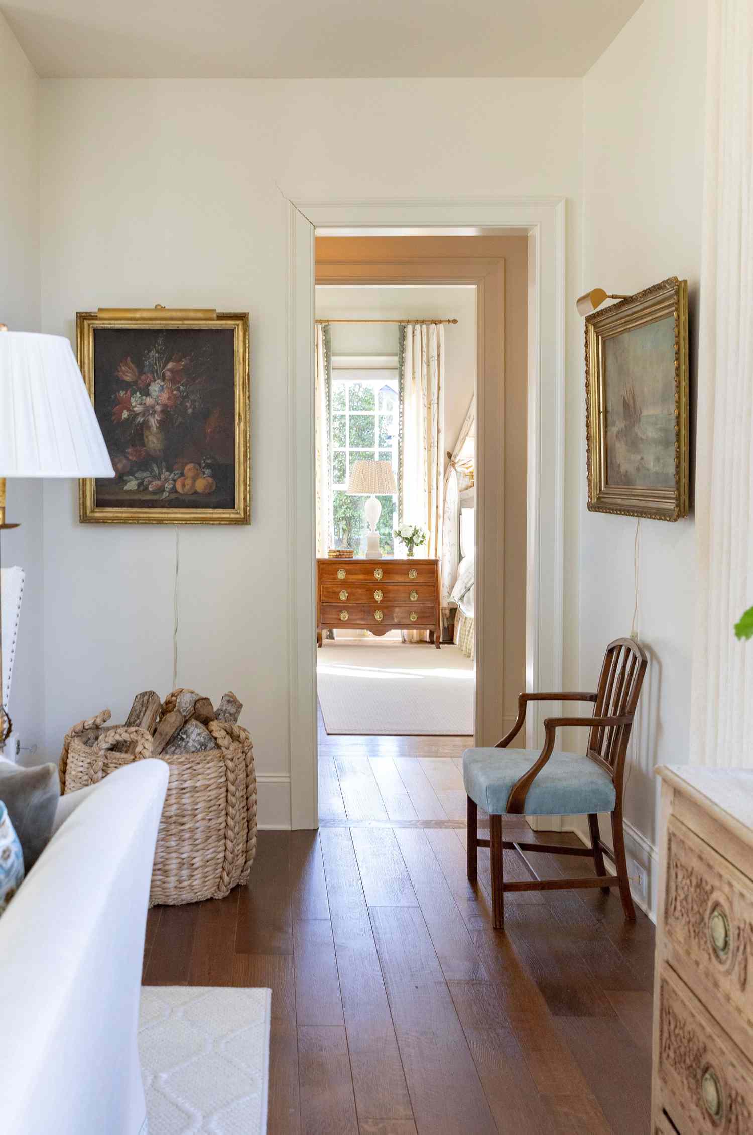 Hallway with seating and gold framed paintings