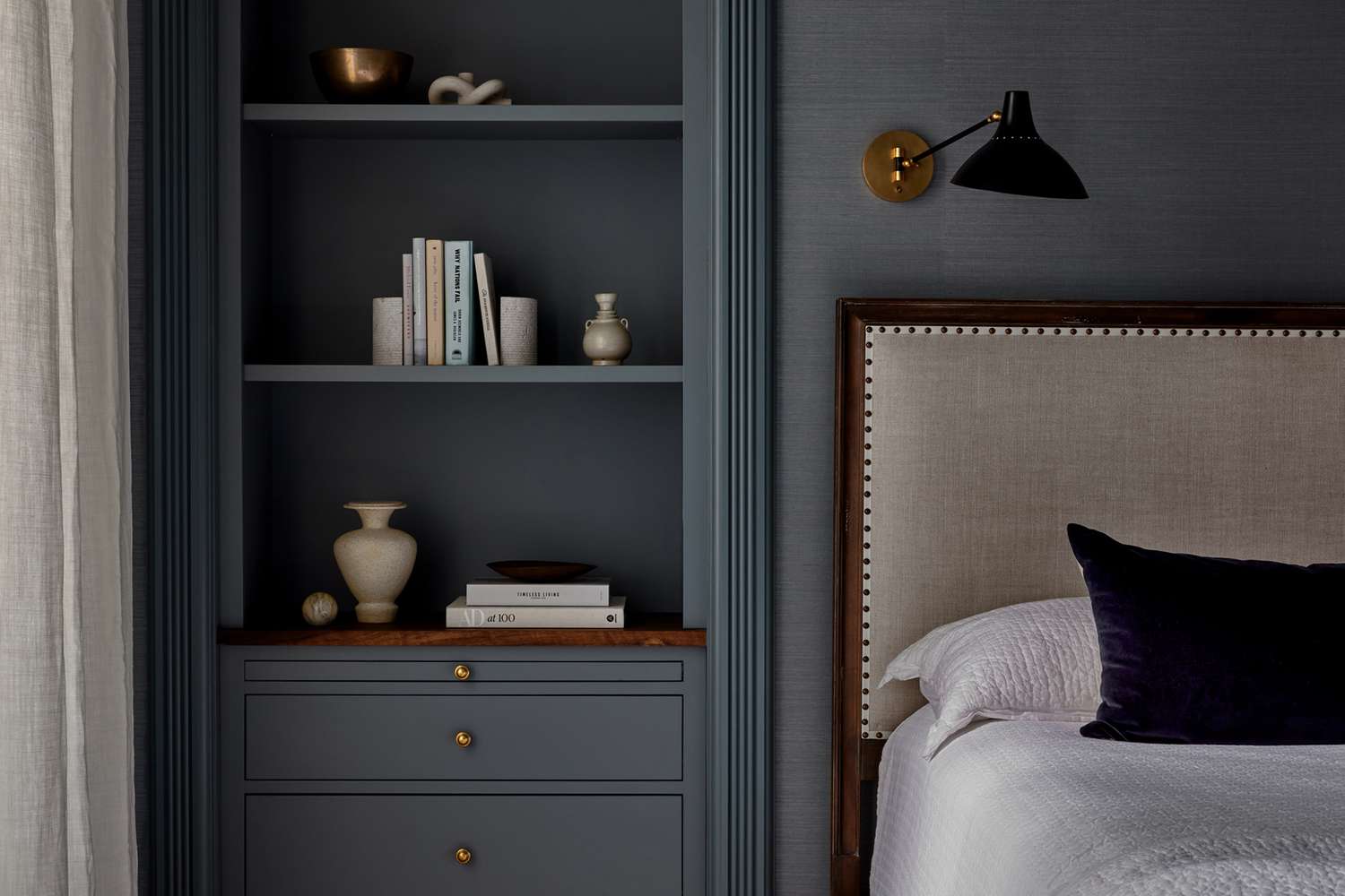 moody bedroom blue shelving near a bed