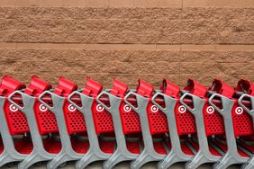 A line of red Target shopping carts against the store.