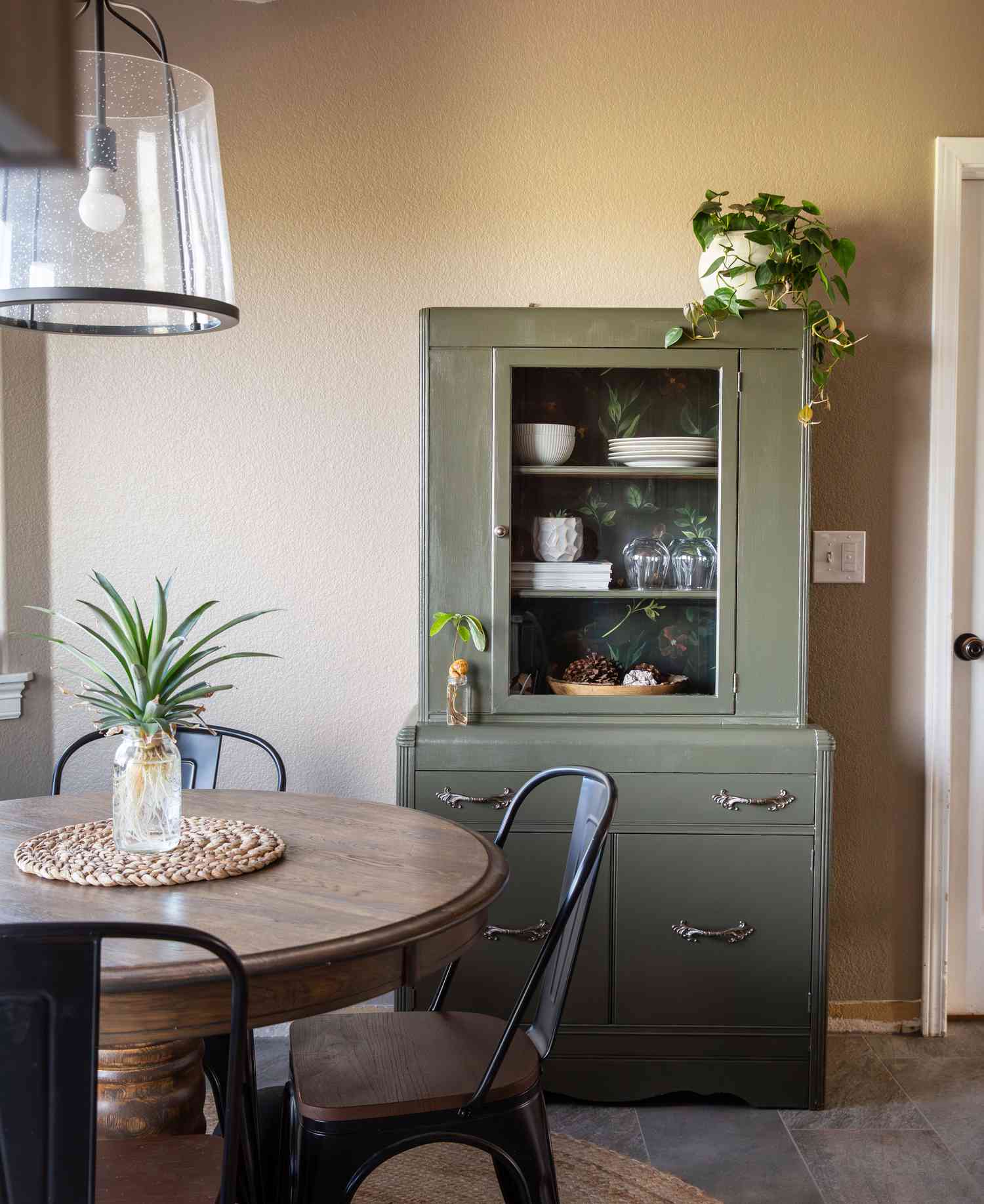 Green thrifted hutch in dining room