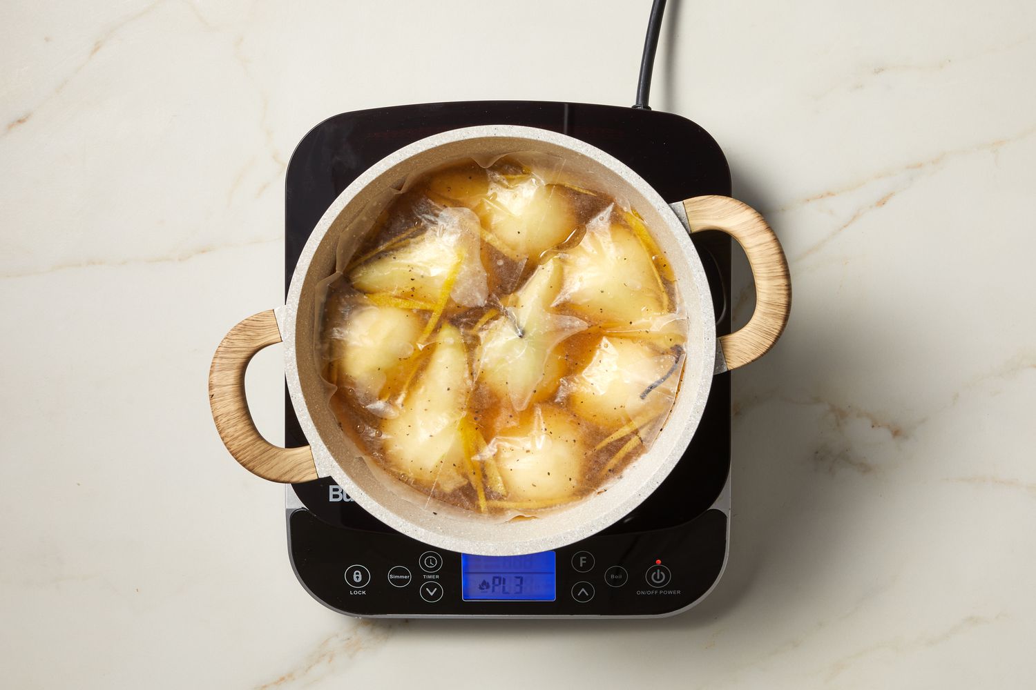 overhead view of pears being poached