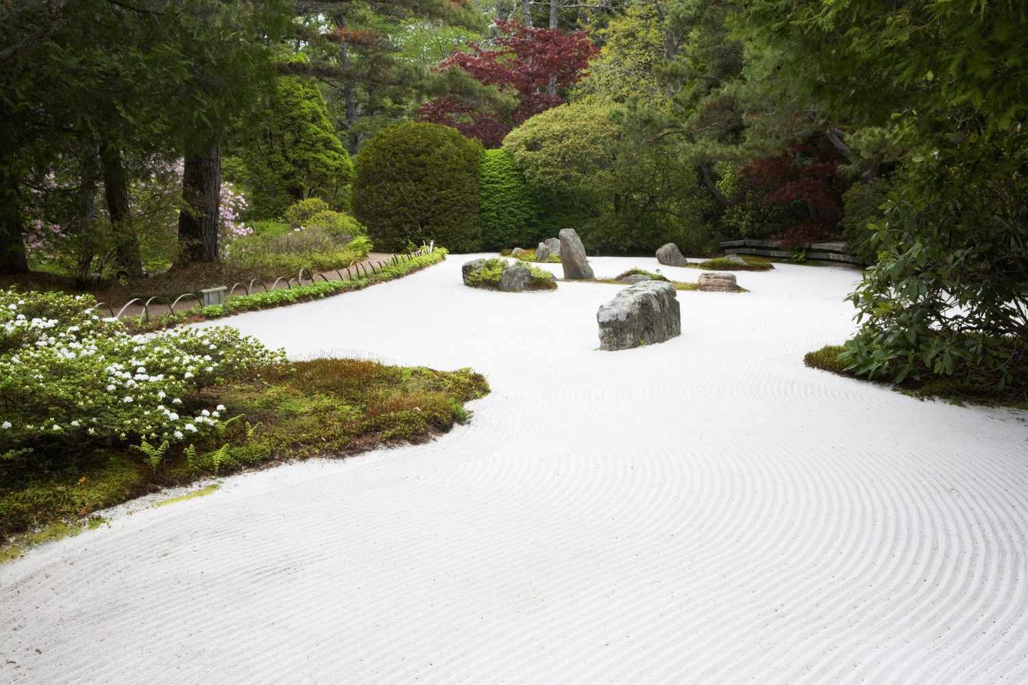 traditional zen rock garden with sand and moss