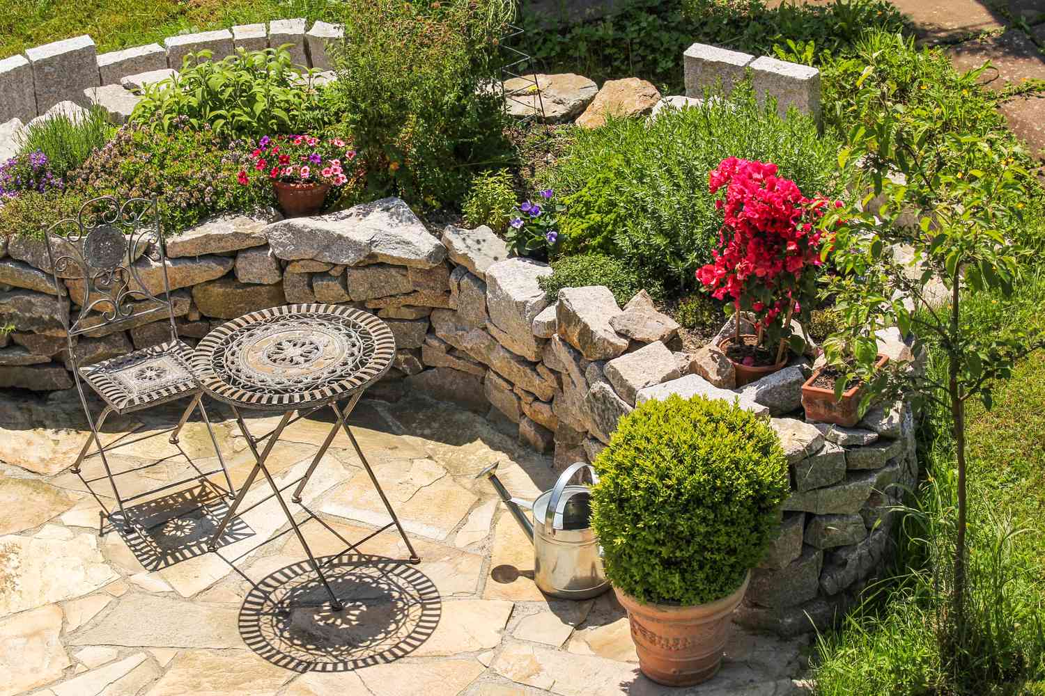 raised flower bed with stones in garden