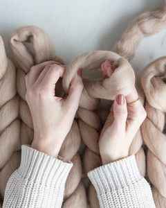 hands forming loop for arm knit blanket