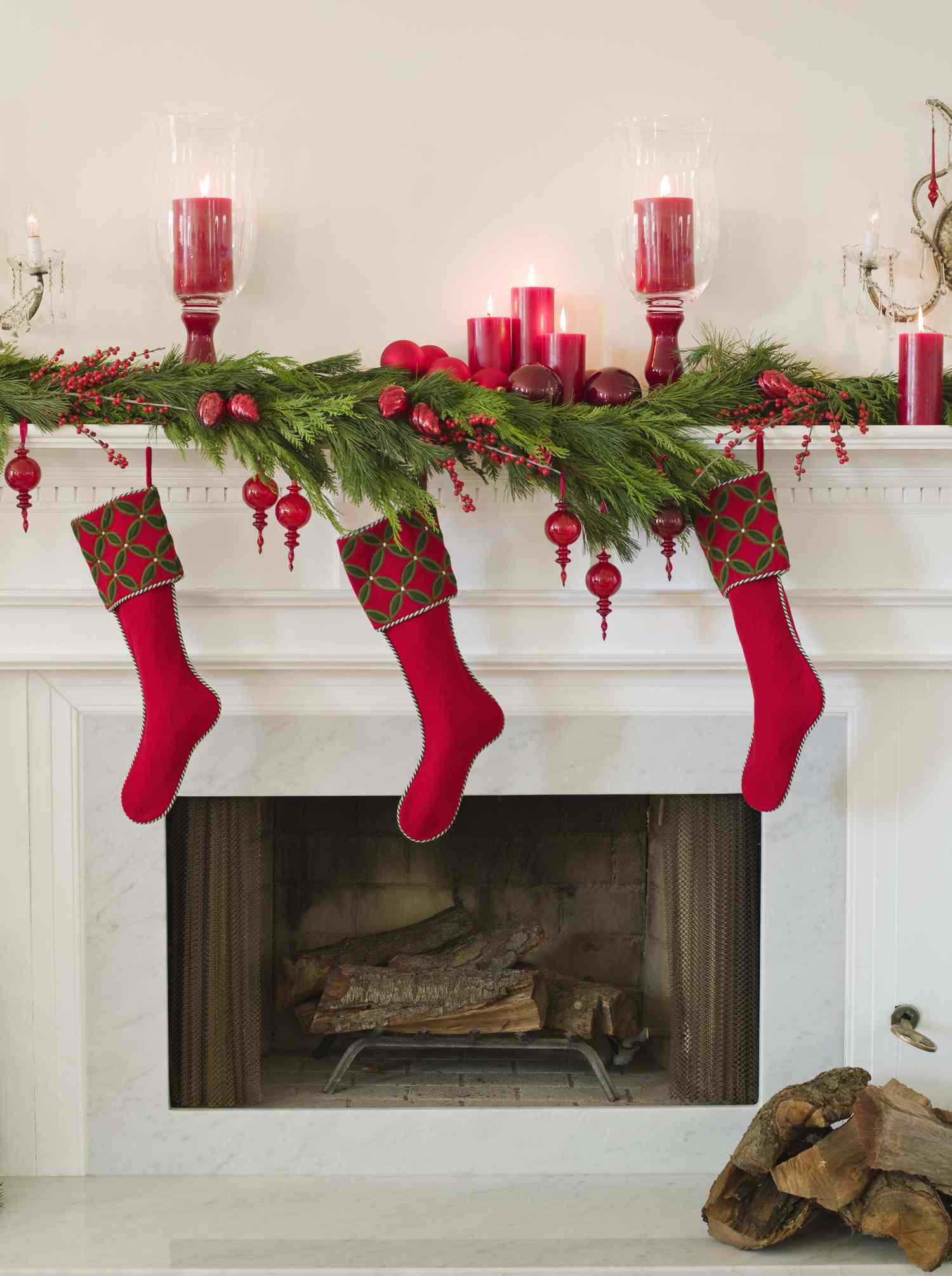 Holidaydecorated fireplace with red stockings and candles