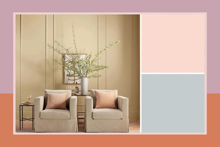 A pair of armchairs with pillows and a table with decor in a styled indoor setting