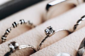 Rows of silver rings in a storage box. 