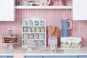 Kitchen countertop with decorative items including a cake utensils and houseshaped ceramics