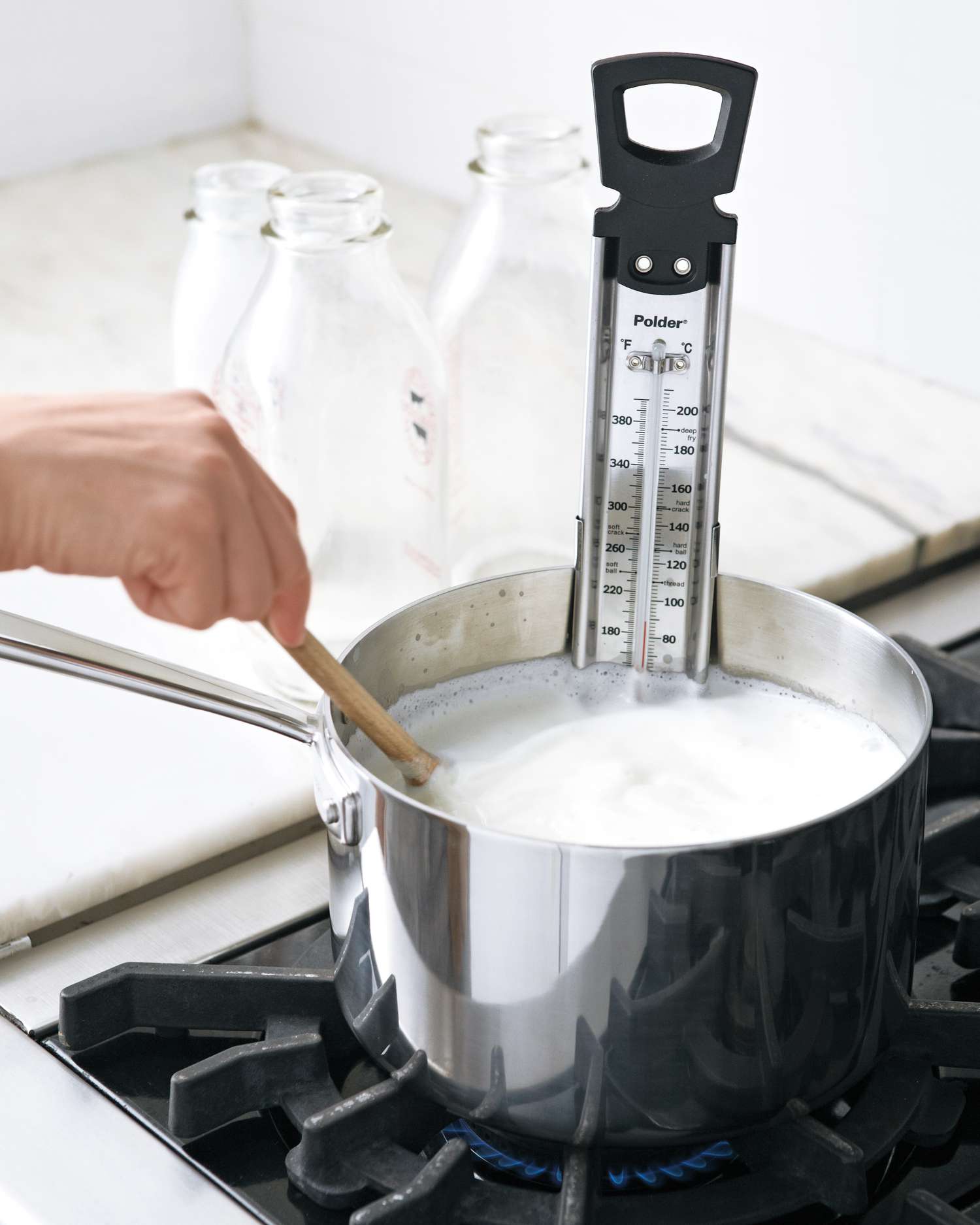 milk and cream being heated on stove for ricotta