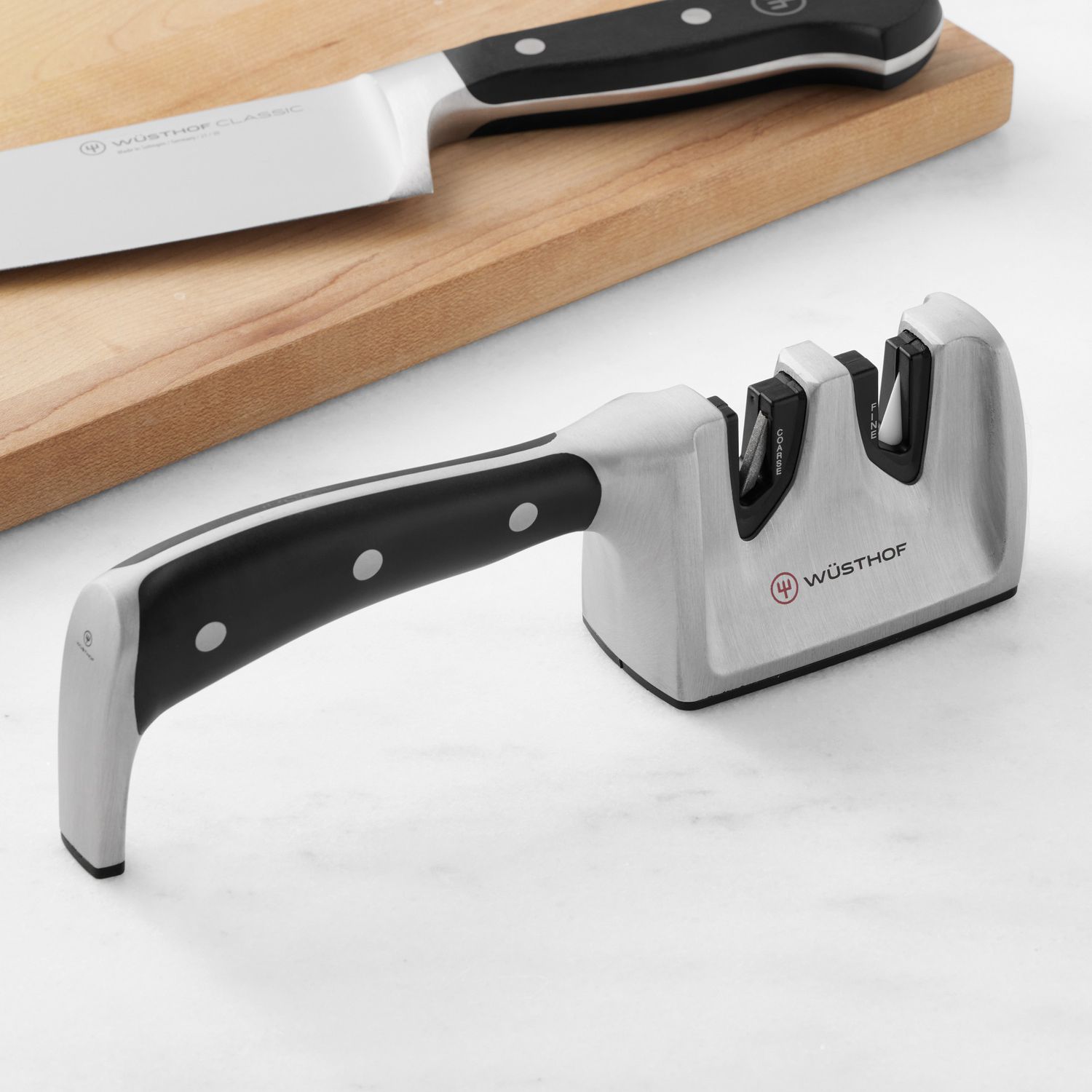 Knife sharpener and kitchen knife on a countertop