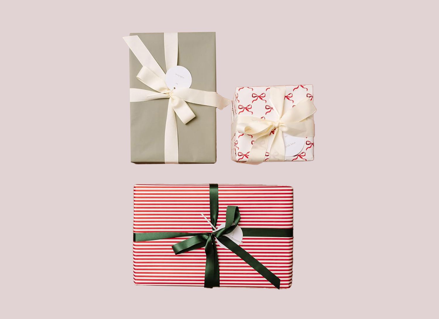 three wrapped gifts on a pale pink background