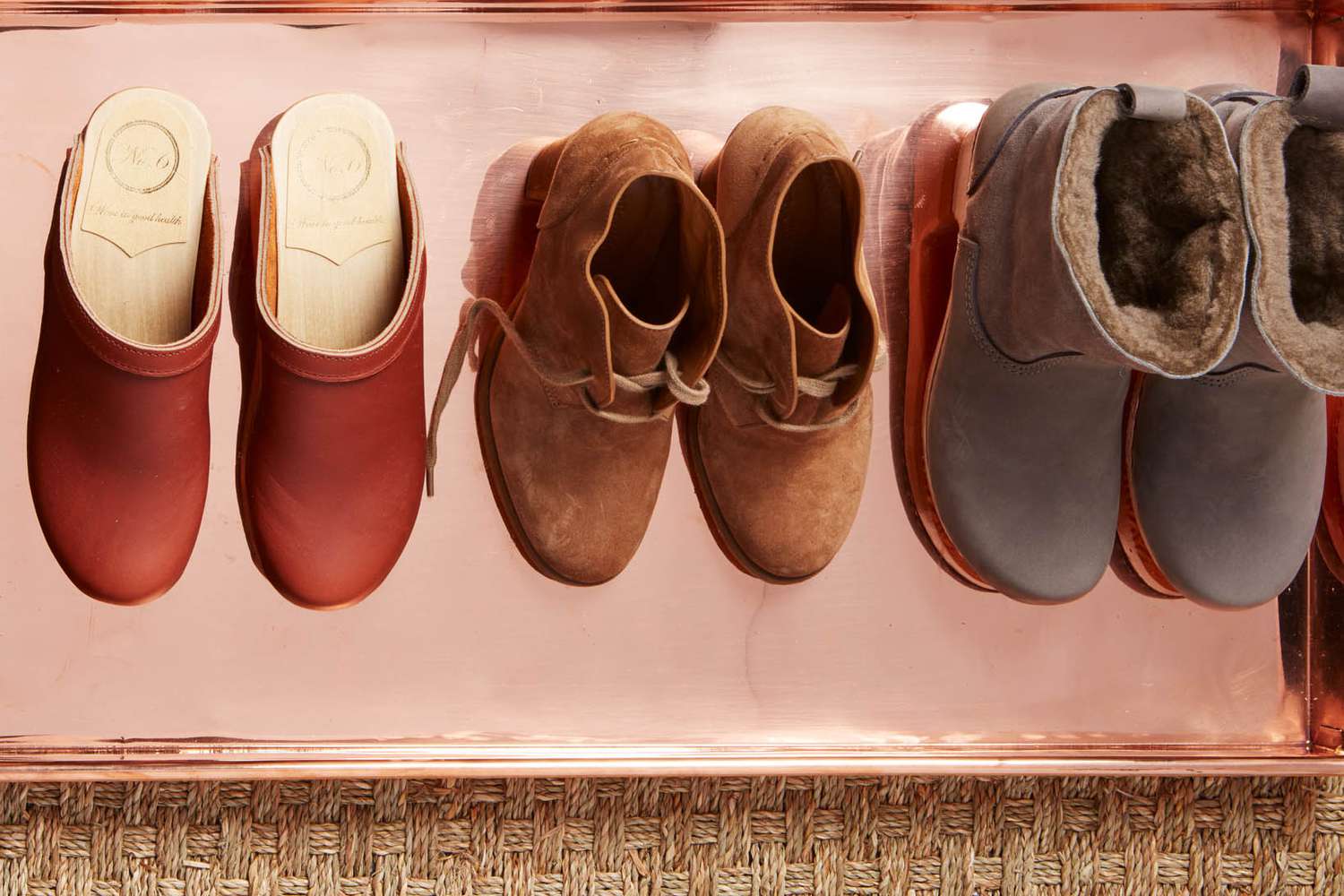 clogs and shoes on tray in entryway
