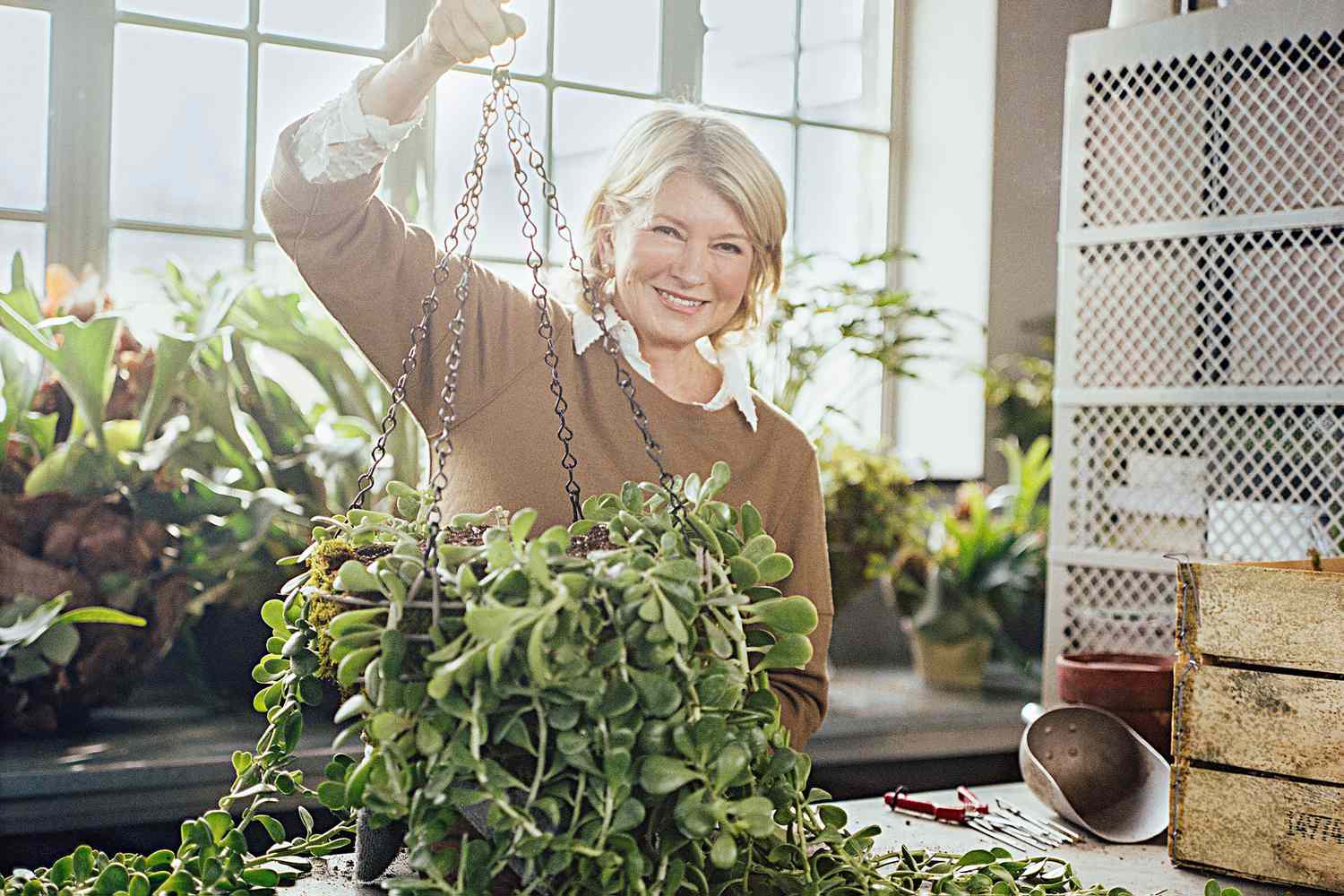 Martha holding hanging plant