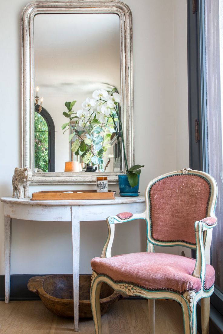 corner decorated with traditional mirror and pink vintage chair