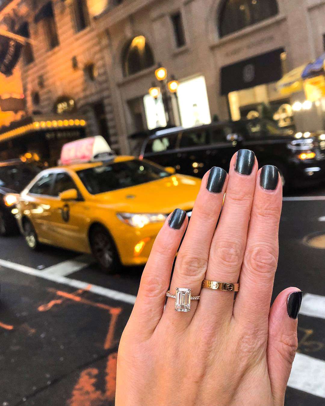 engagement ring selfie cityscape with yellow taxi cab in background