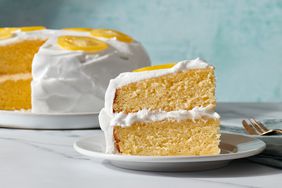 lemon cake slice on plate with rest of cake on another plate