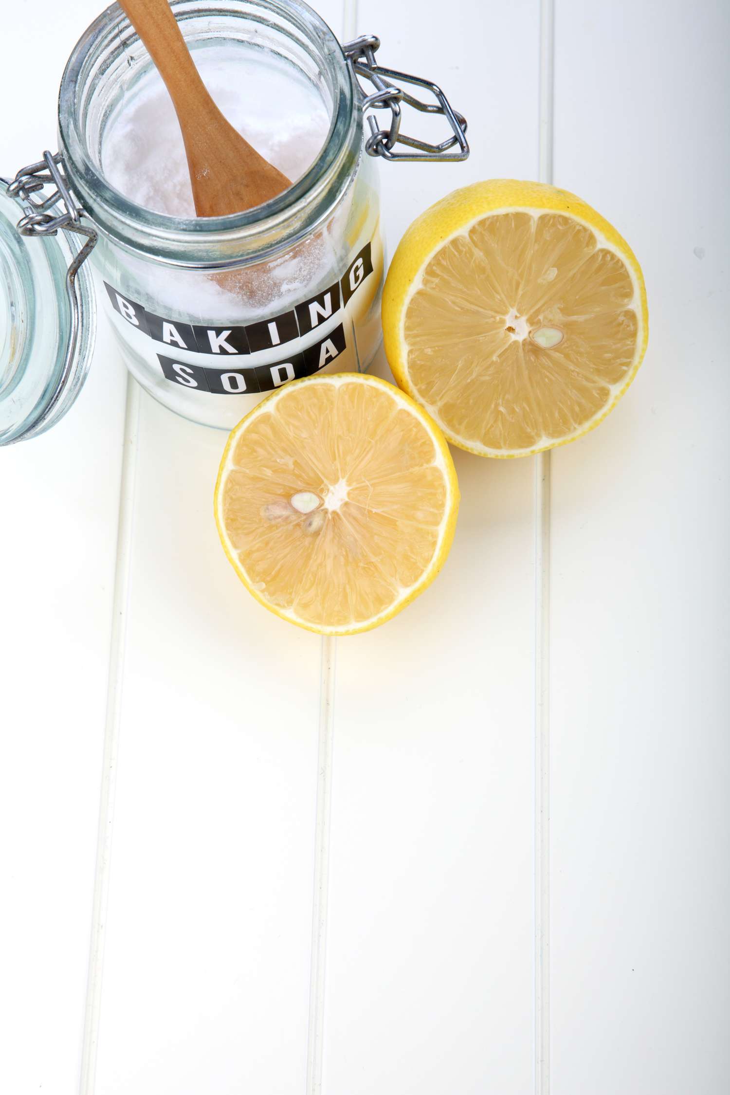 jar of baking soda and a sliced lemon