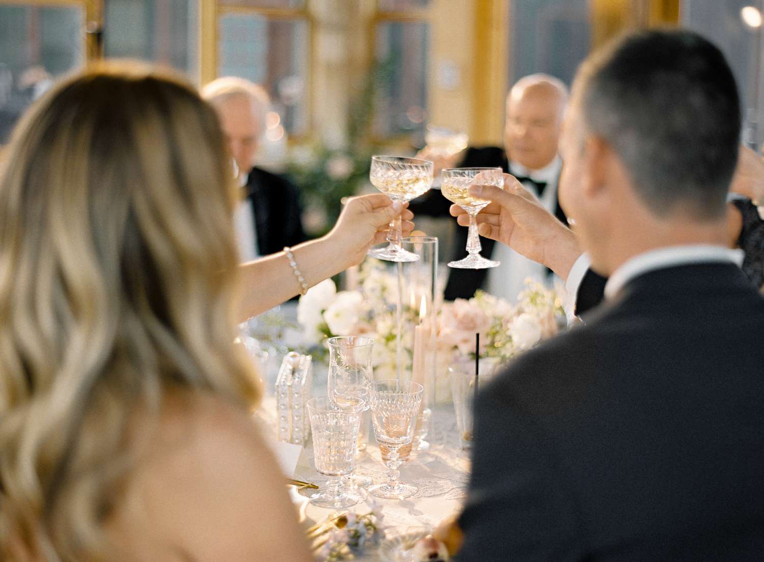 bride and groom toasting at wedding reception