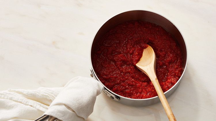 cooked pizza sauce pot red wooden spoon