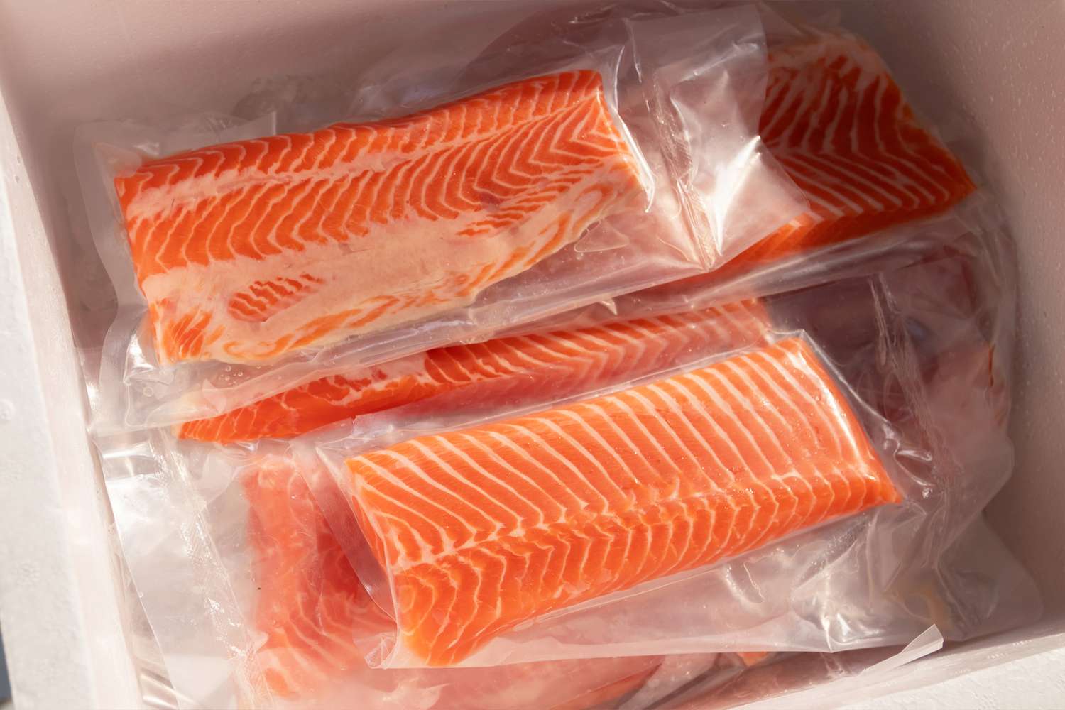Packaged salmon fillets arranged in a container
